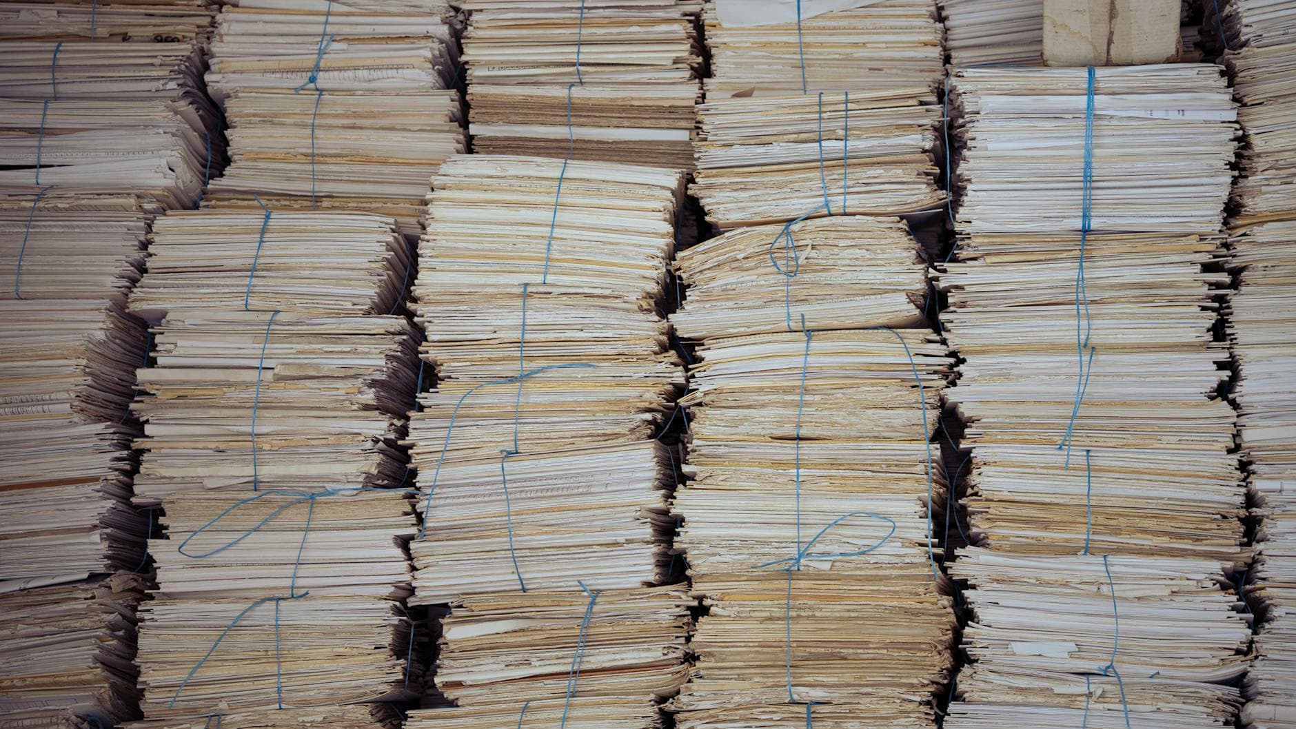 A stack of typical apostille files — Ontario birth certificate, RCMP check, notarized degree, sworn affidavit, and translator's affidavit — in an Ottawa notary office, illustrating where each document goes for authentication