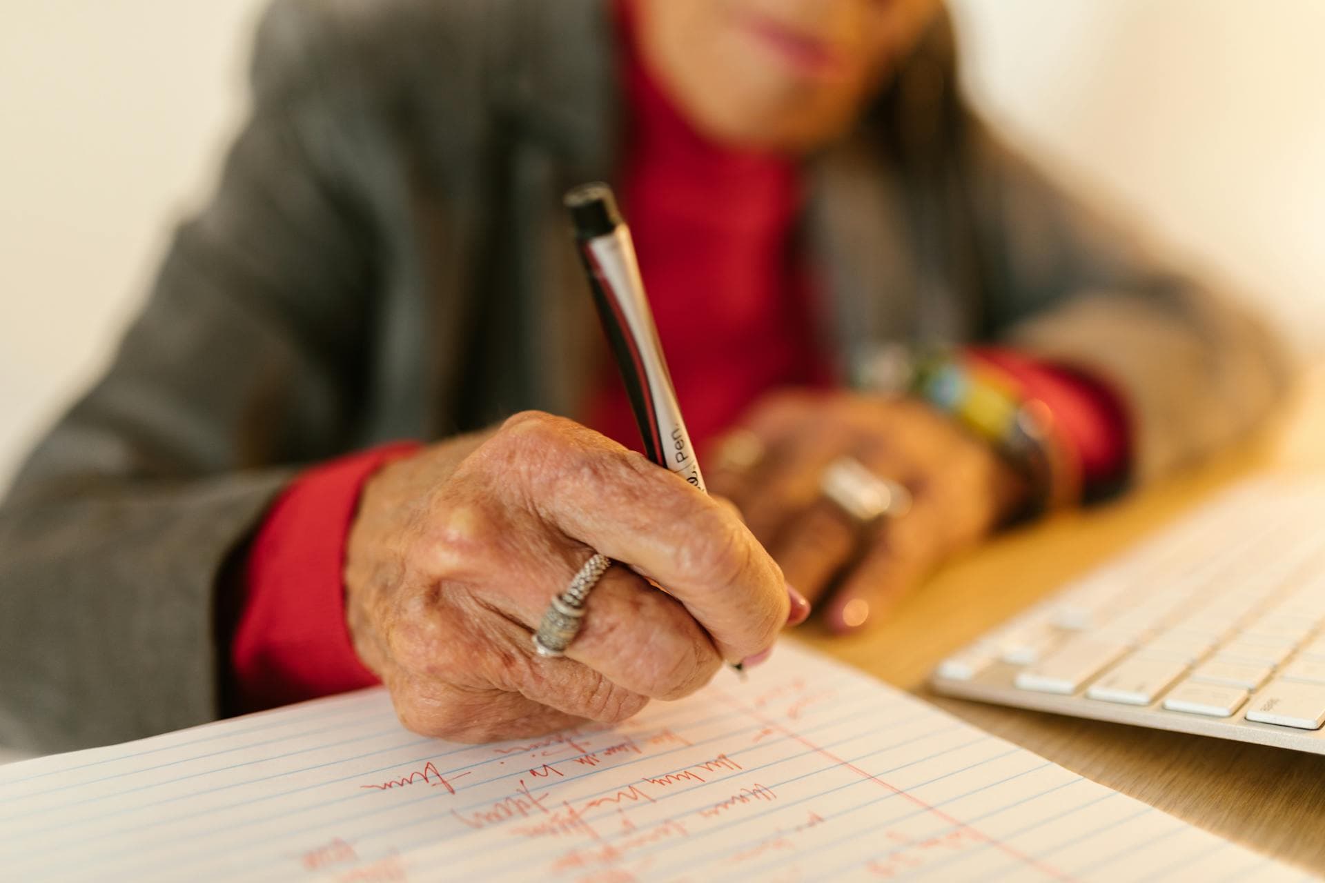 Notary listening to a patient at bedside, two empty chairs nearby, soft window light