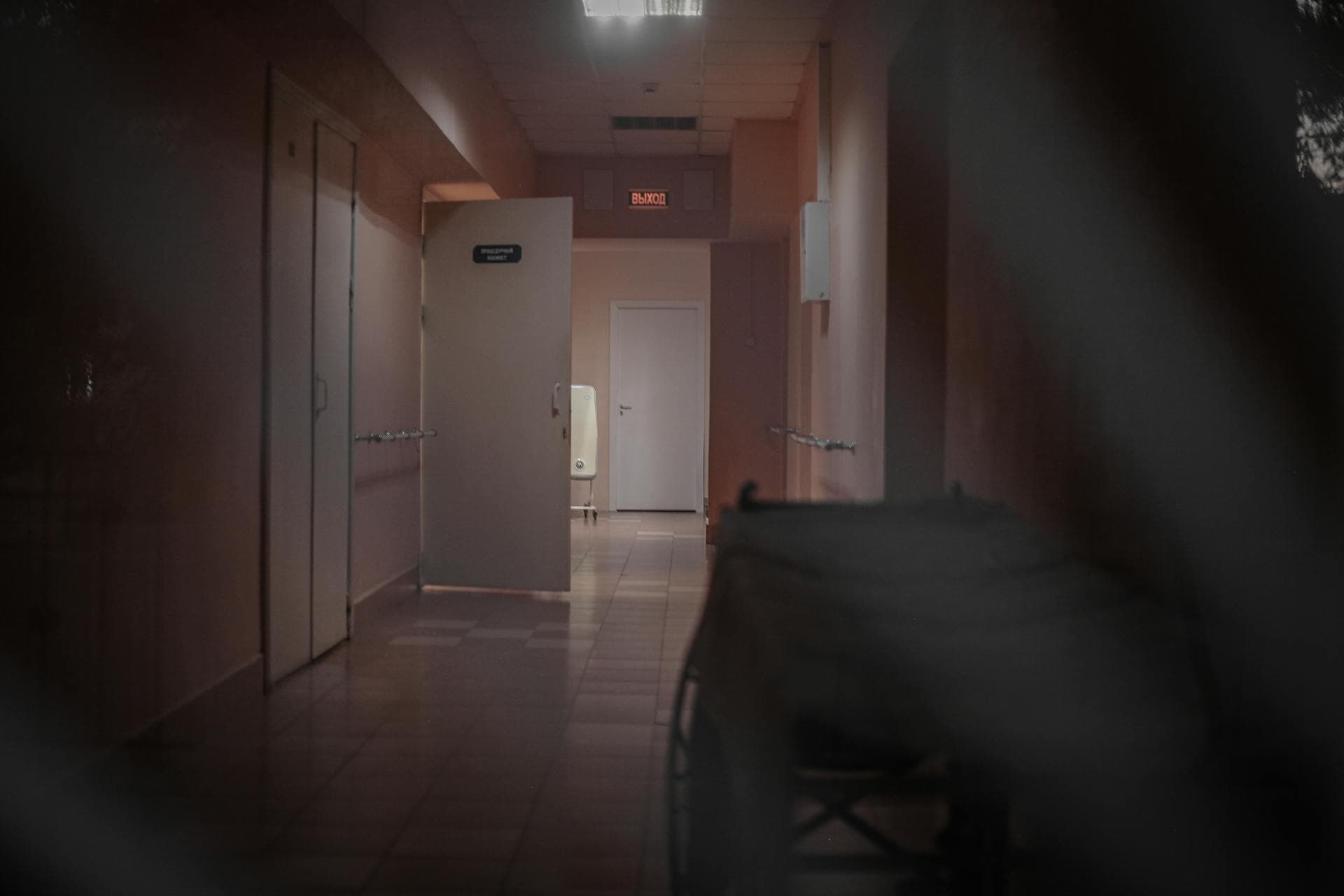 Empty hospital corridor at night with soft lighting, Ottawa bedside notary visit context