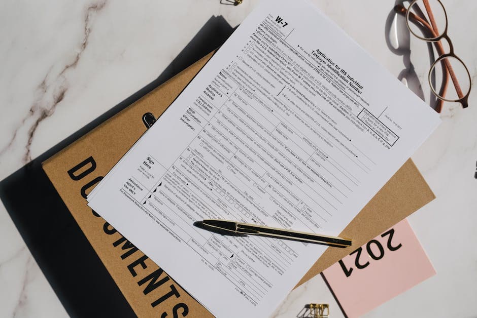 A blank IMM 5409 form on a desk beside two passports, a pen, and a notary seal