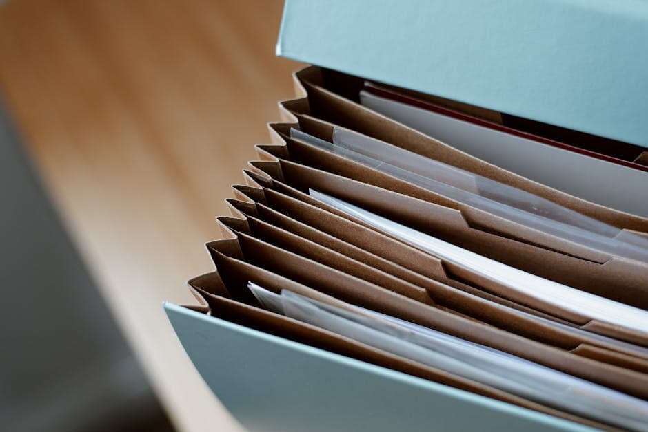 A folder labelled "IMM 5409" beside a folder labelled "supporting evidence" on a desk, with a notary seal in the foreground