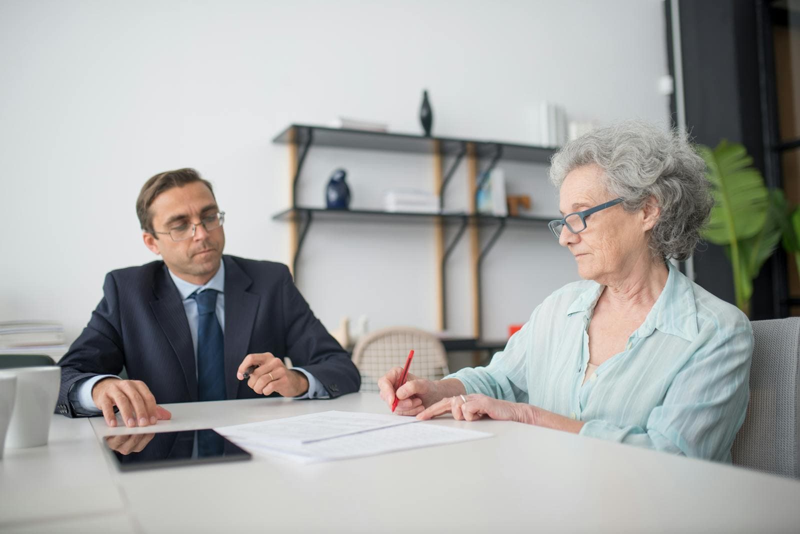 Mobile notary witnessing a continuing power of attorney for property at an Ottawa condo dining table, with two qualified witnesses present