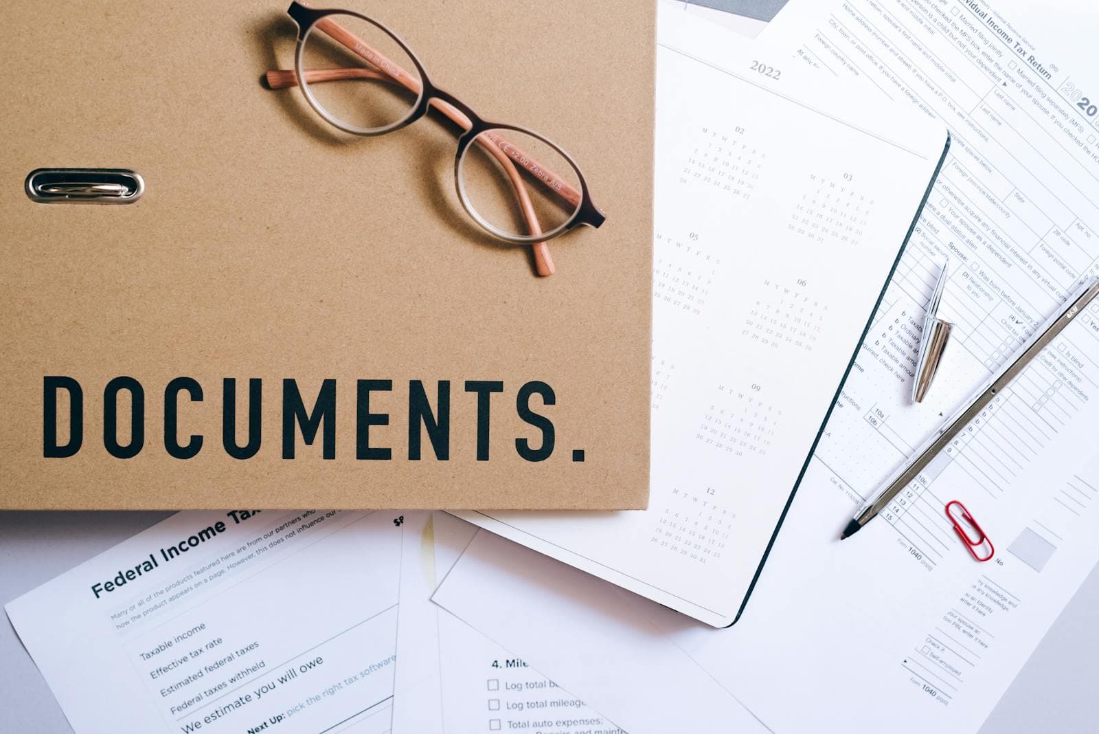 A grantor's folder containing a drafted continuing power of attorney for property, government photo identification, and a lawyer's capacity letter, ready for an Ottawa notary appointment