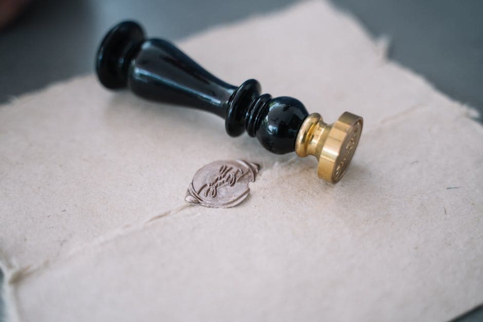 A notary's seal pressed onto a printed lost-passport statutory declaration with a Canadian passport application beside it