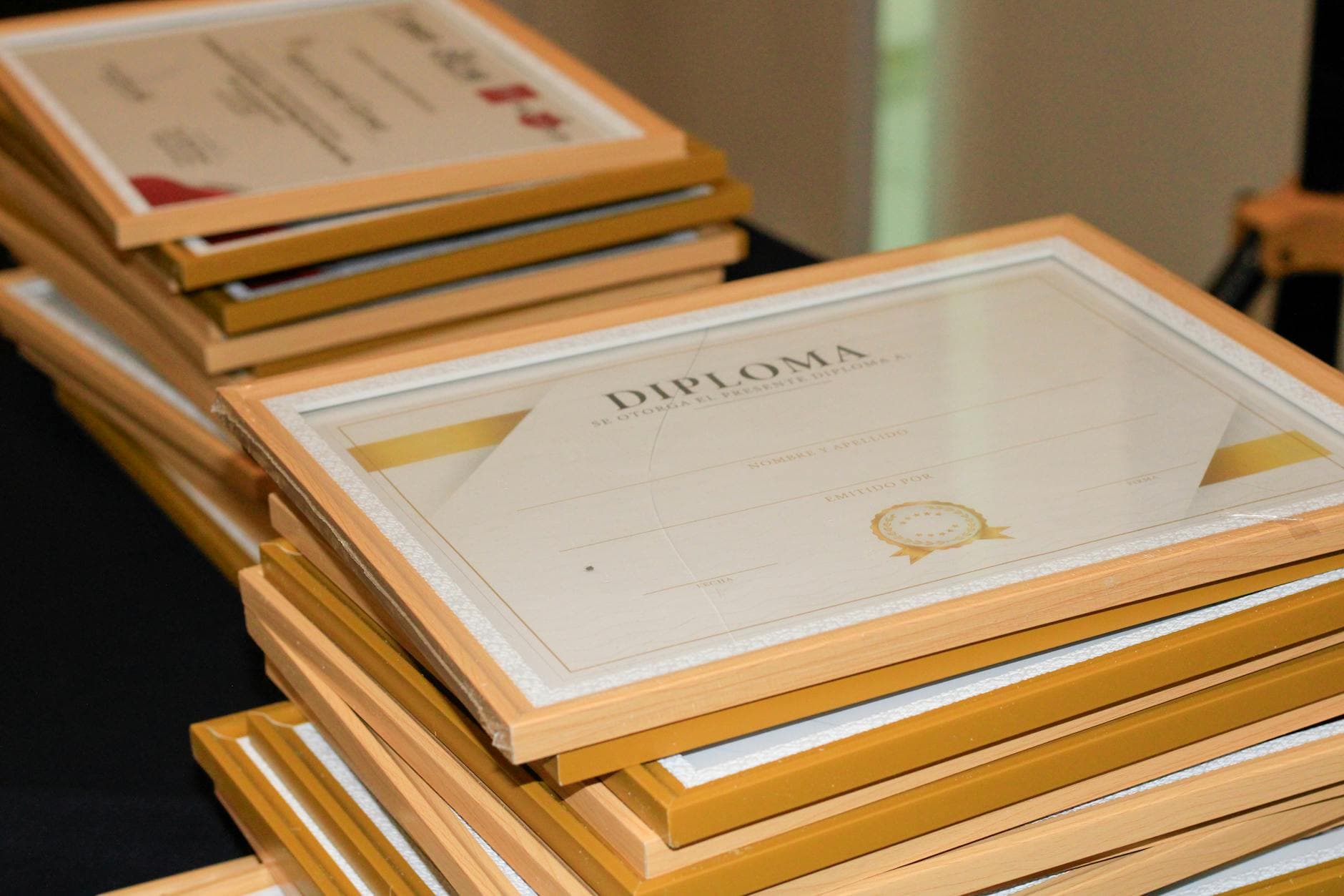 A close-up of a B.Ed. parchment, an out-of-province teaching certificate, and a passport laid out for the certified true copy step at an Ottawa notary's desk