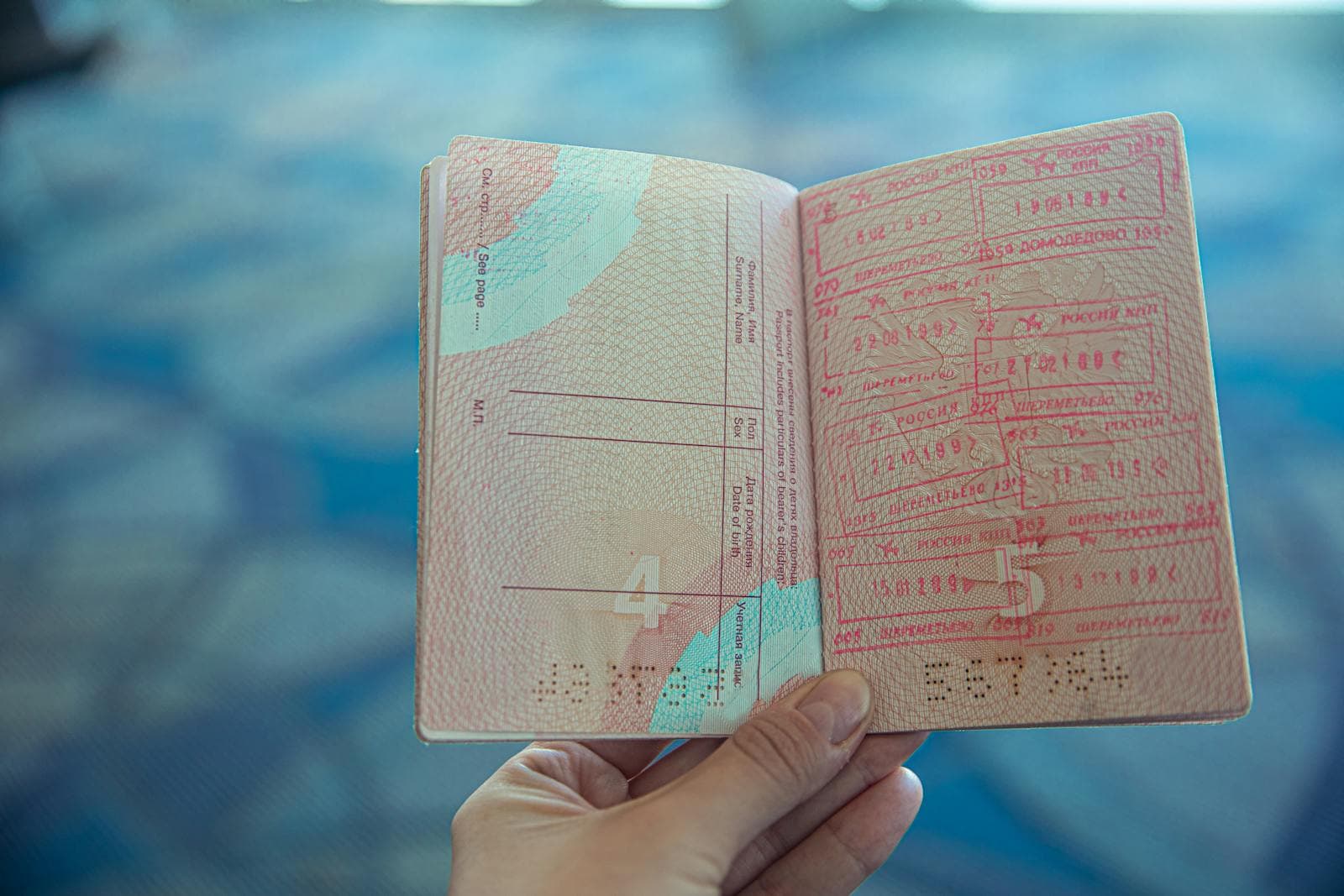 Two pieces of Canadian government ID — a passport and an Ontario driver's licence — laid beside a printed letter of invitation, ready for an Ottawa notary appointment