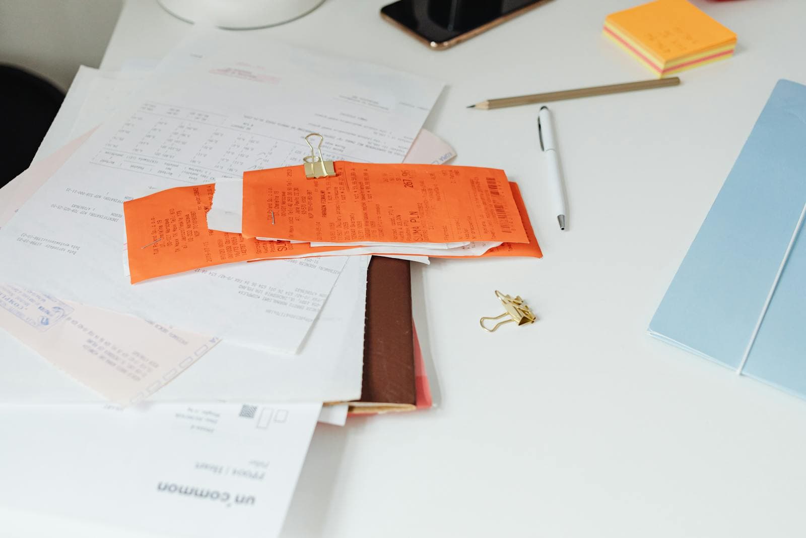 A printed letter of invitation, a photocopied citizenship card, and a Notice of Assessment laid out together on a desk for an Ottawa Super Visa file