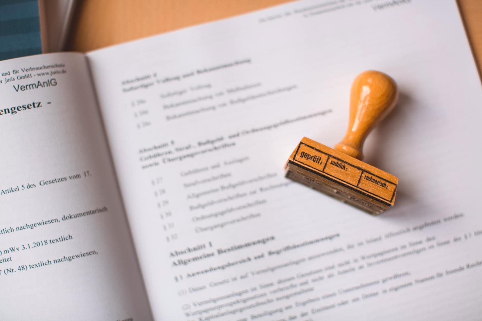 A notary's printed seal beside a signed page of a letter of invitation, with a folder of immigration documents nearby on a tidy office desk in Ottawa