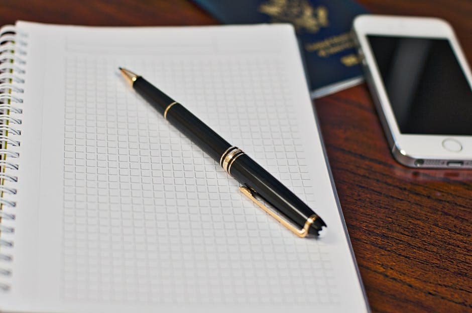 Canadian passport, photocopies, and a pen on a desk being prepared for certified true copies