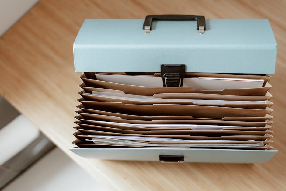 Folder of documents and a driver's licence on a wooden desk, ready for a notary appointment in Ottawa
