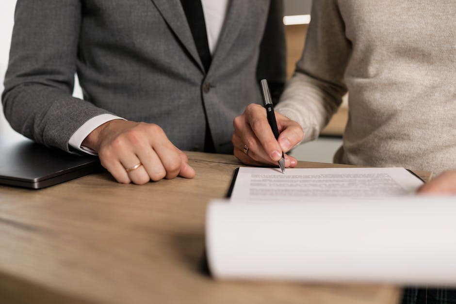 Client signing a contract while a professional witnesses, showing the witnessing step a notary public in Ontario can perform
