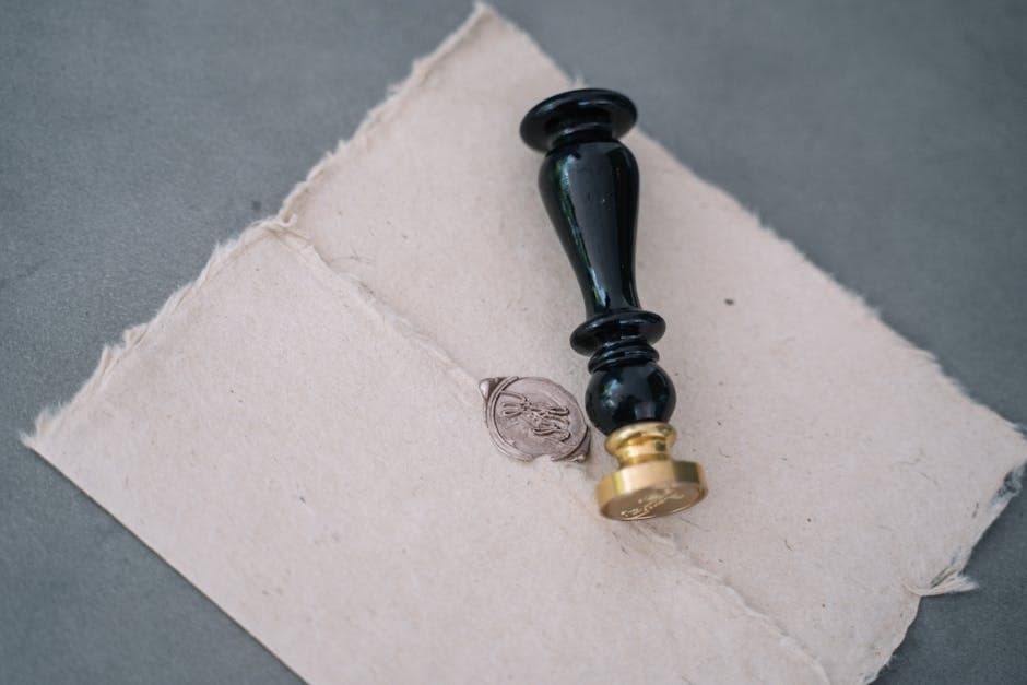 Notary stamp, pen, and a signed agreement on a wooden desk in an Ottawa office, illustrating notary vs lawyer Ontario